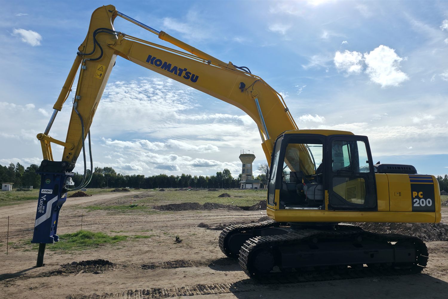 Excavadora sobre orugas con martillo hidráulico en un terreno en preparación
